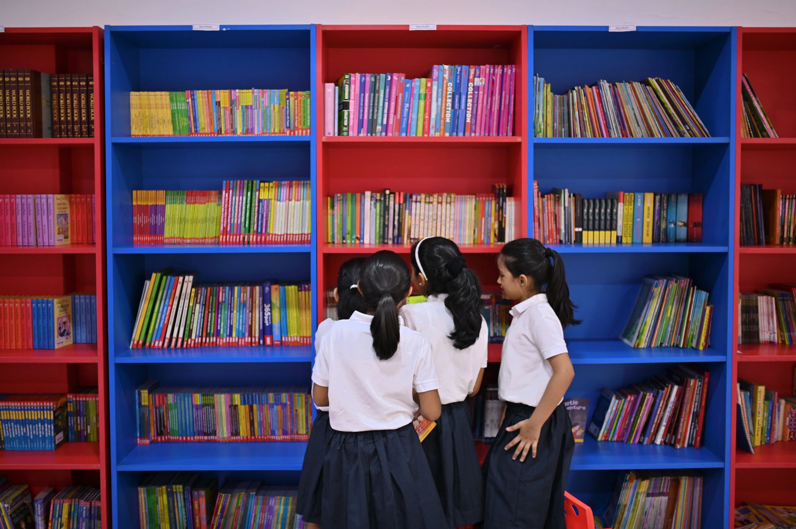 Children selecting books in a school library