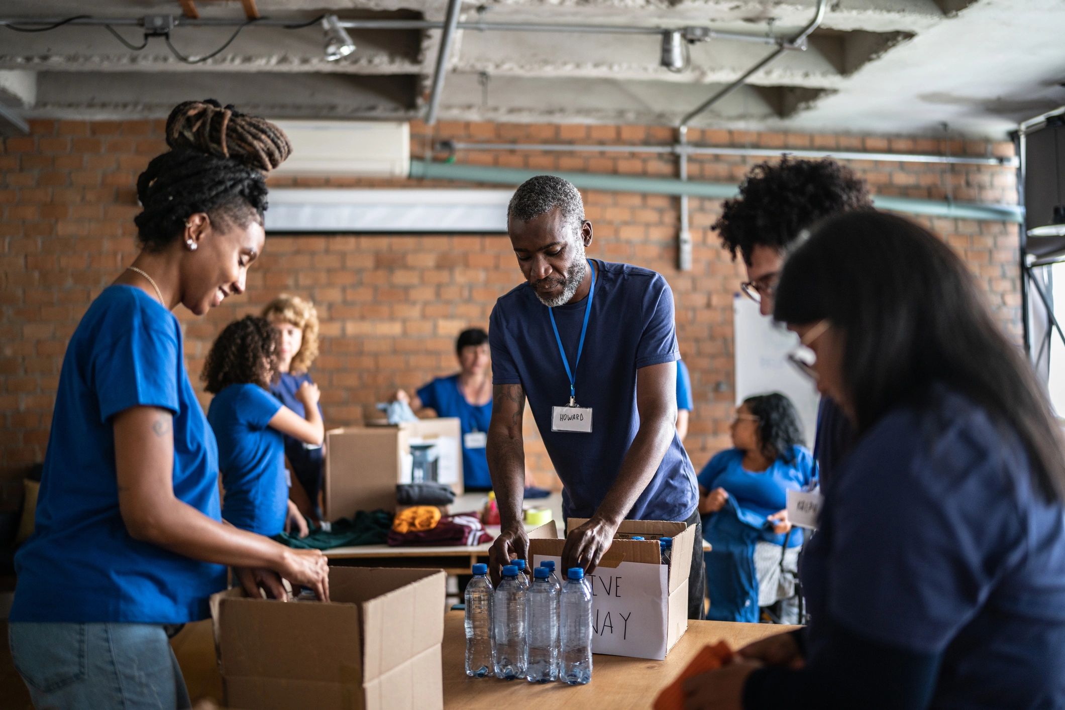 Volunteers organising donated items at a community charity centre