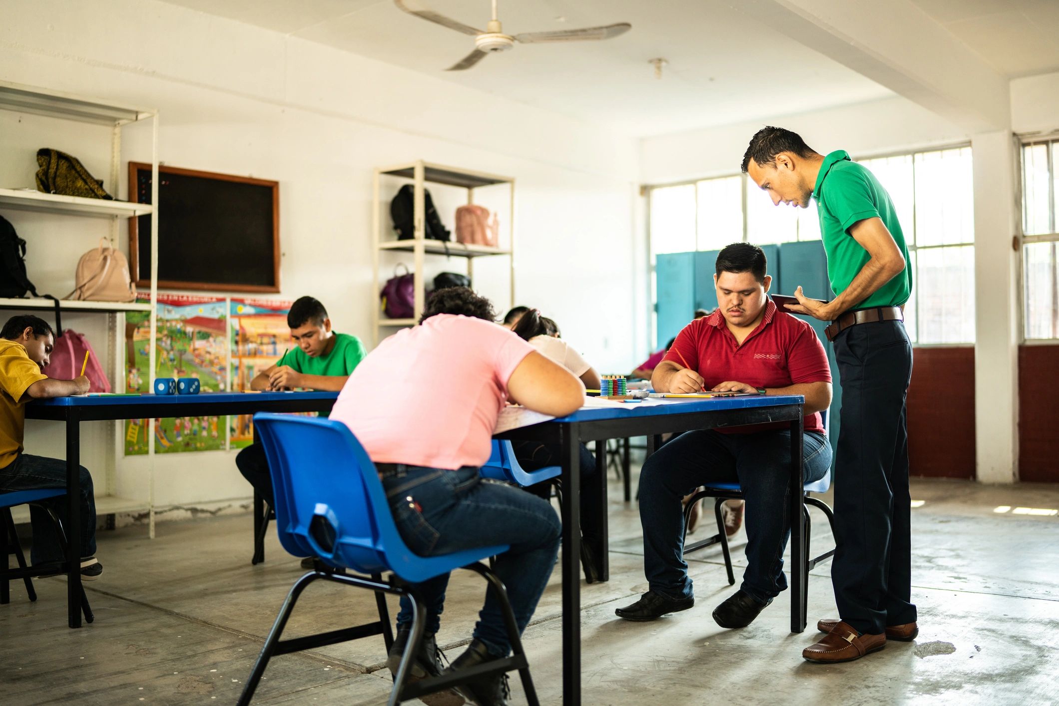 Teacher explaining a lesson to students in a classroom