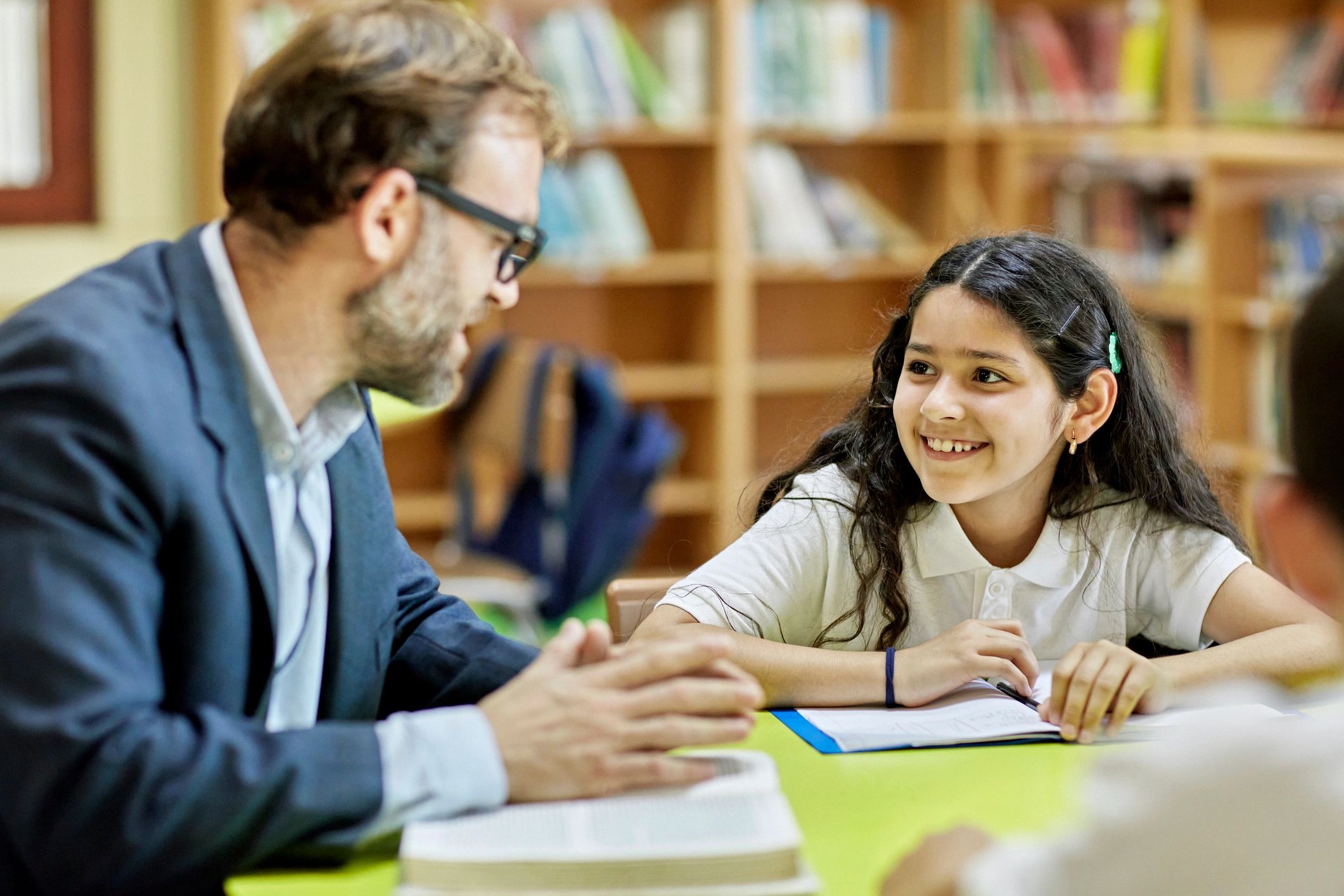Educator speaking with children during a reading session