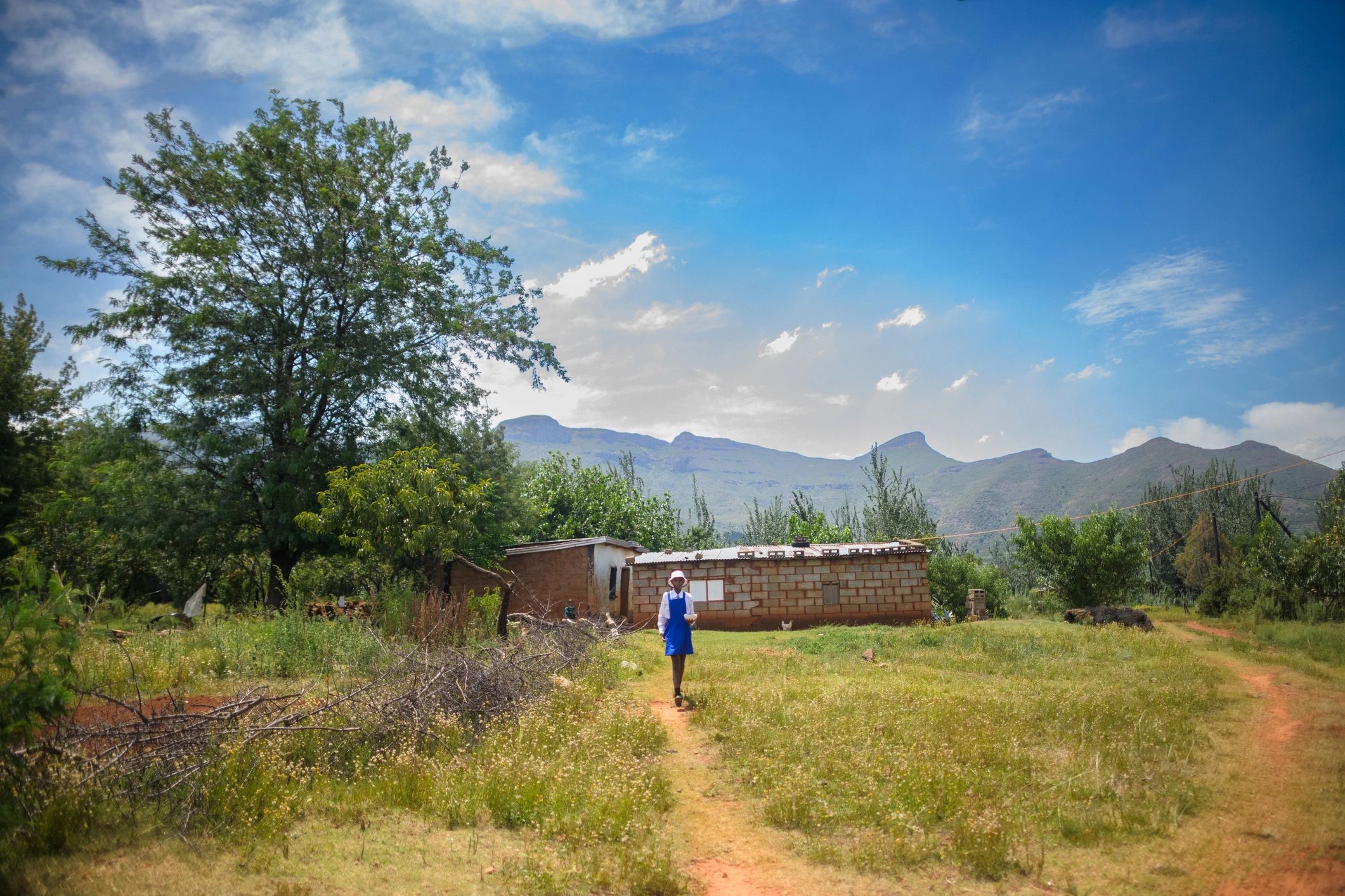Schoolgirl in uniform walking outdoors in a rural community