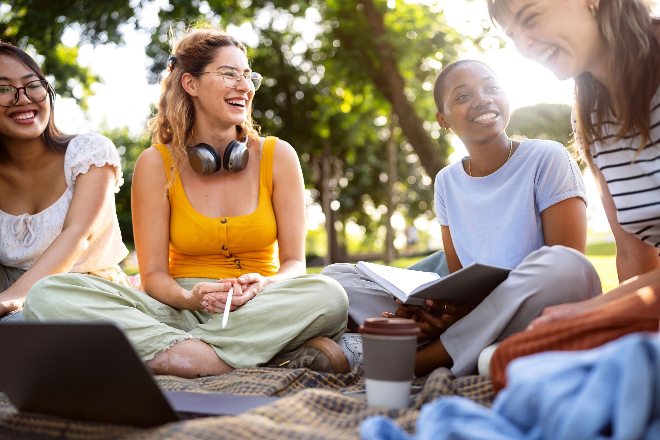 Young people studying together outdoors on a campus