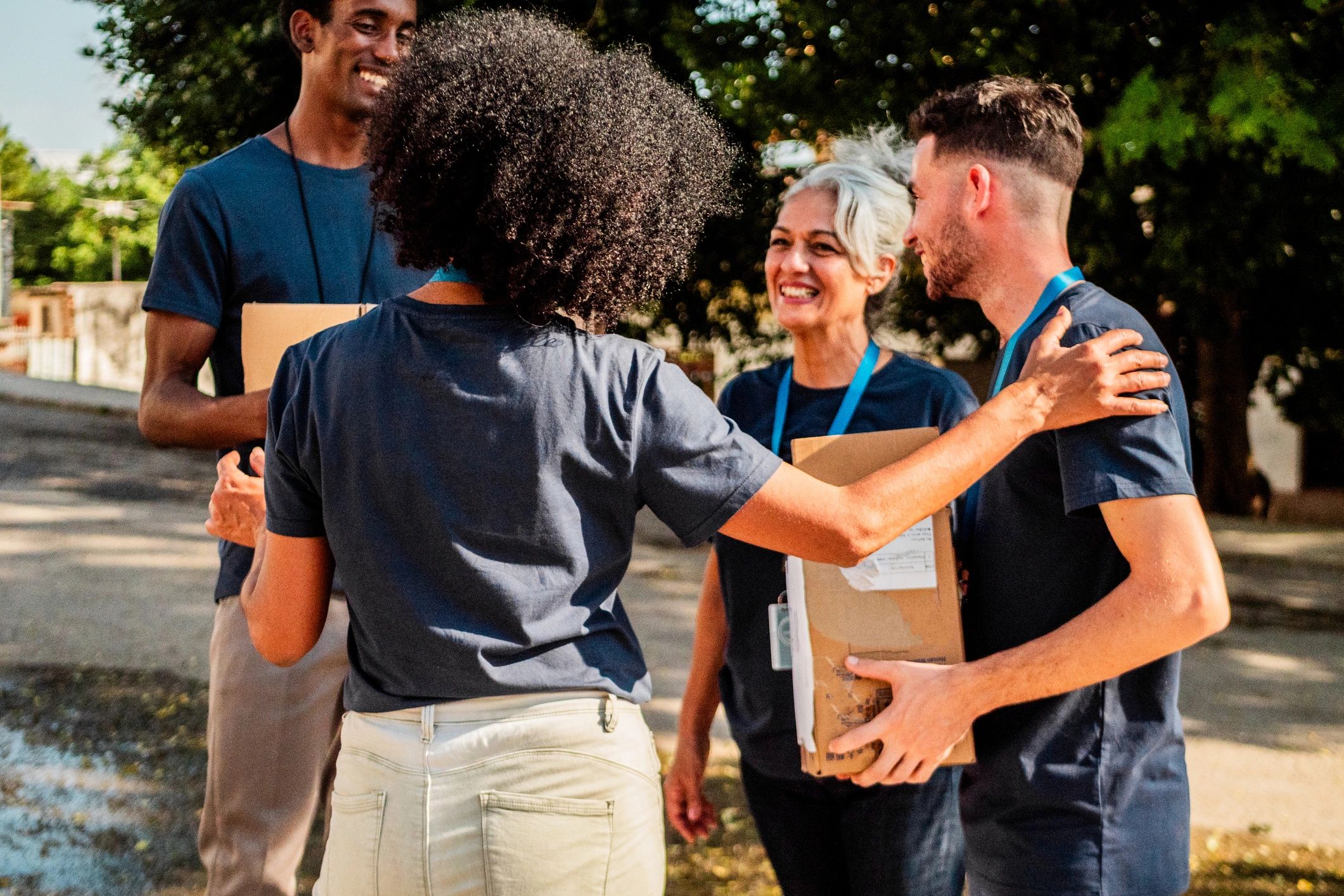 Volunteers holding donation boxes during a community event