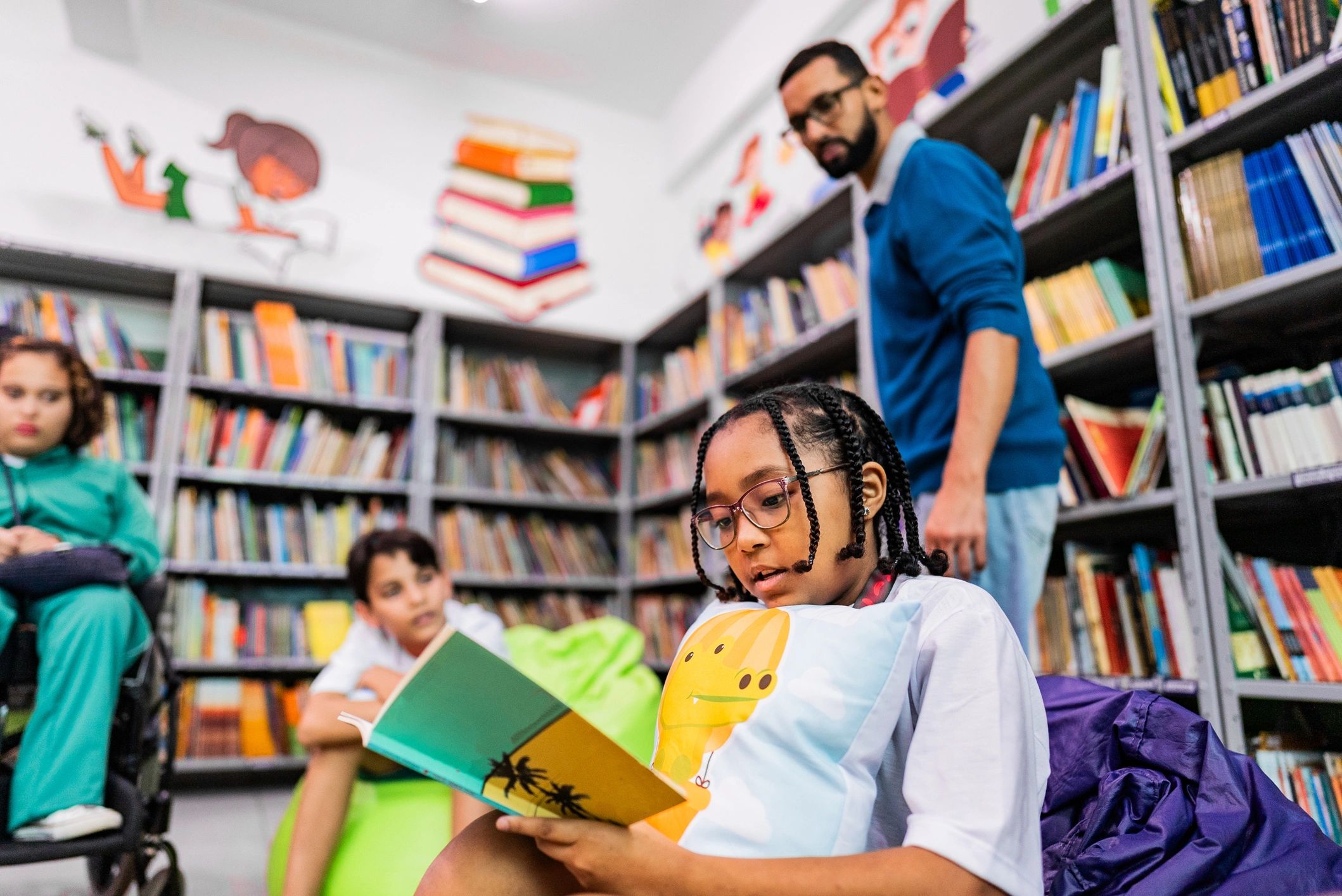 Child reading aloud during a group activity in a school library