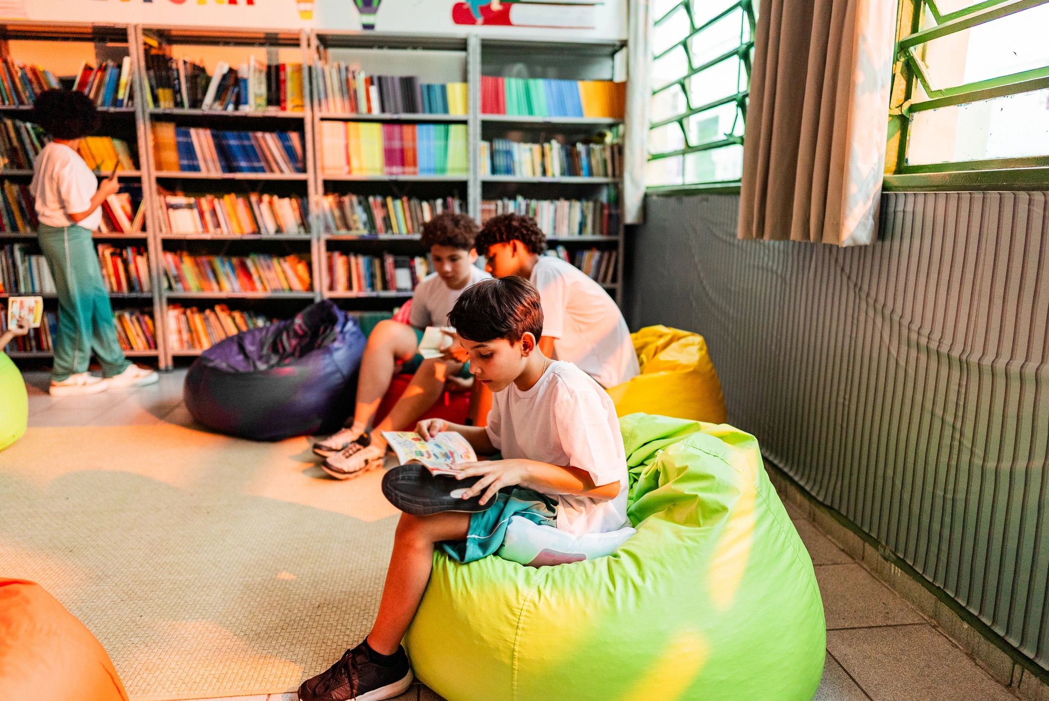 Child reading a book in a school library