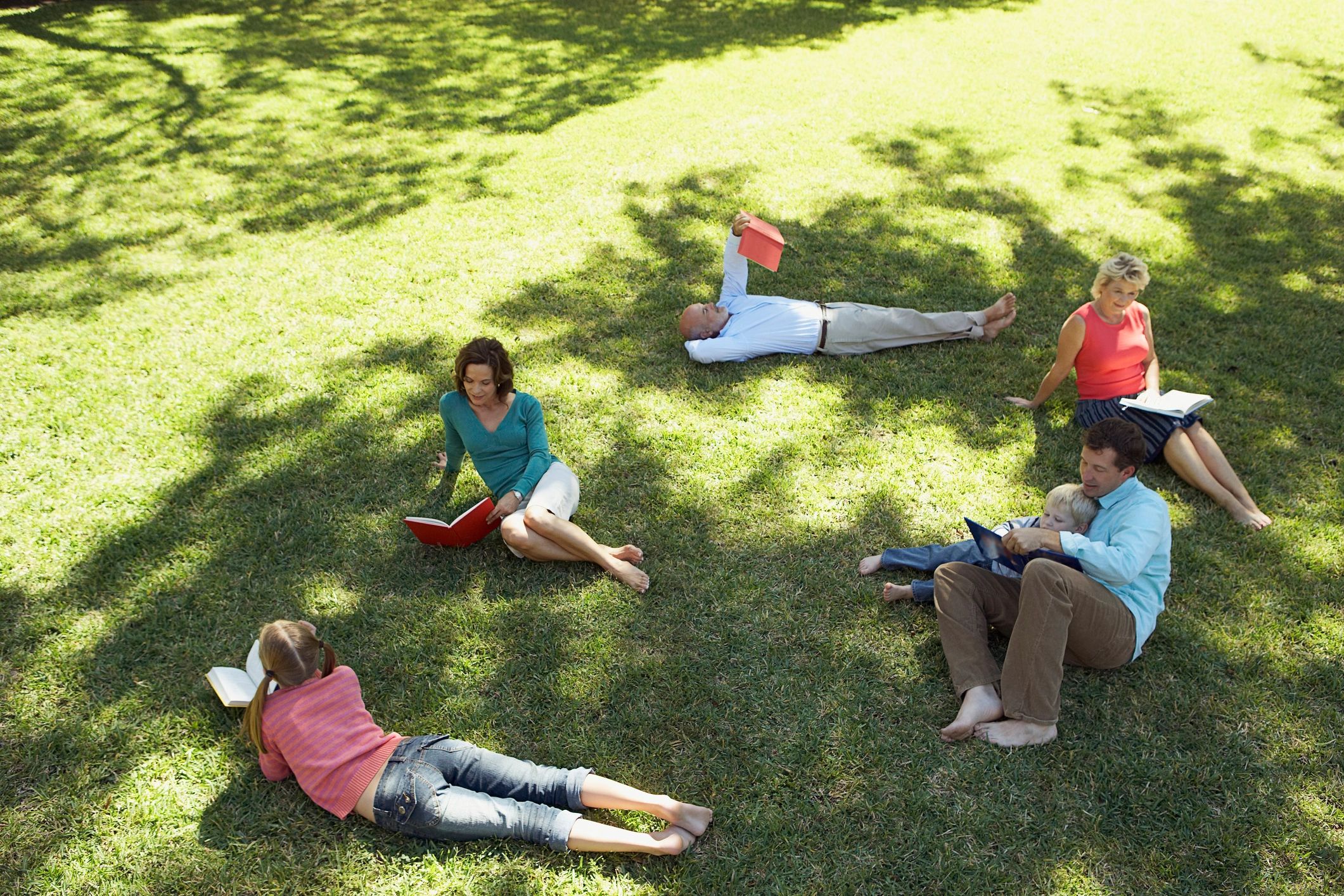 Community group reading together outdoors
