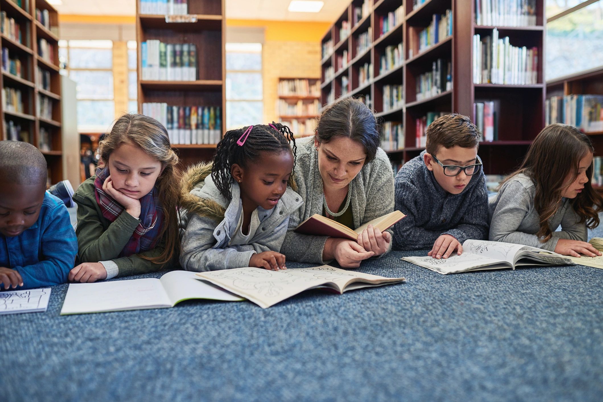 Children reading together in a library